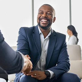 Businessman smiling while shaking someone's hand
