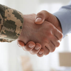 Handshake of a soldier and a businessman