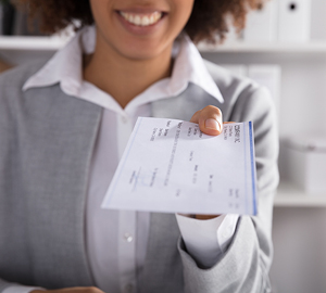 Young woman holding a cashiers check.